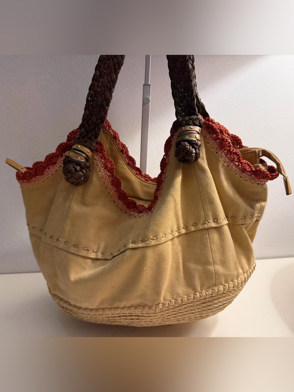 The Sak tan canvas Indio hobo bag with braided brown straps and crochet trim
